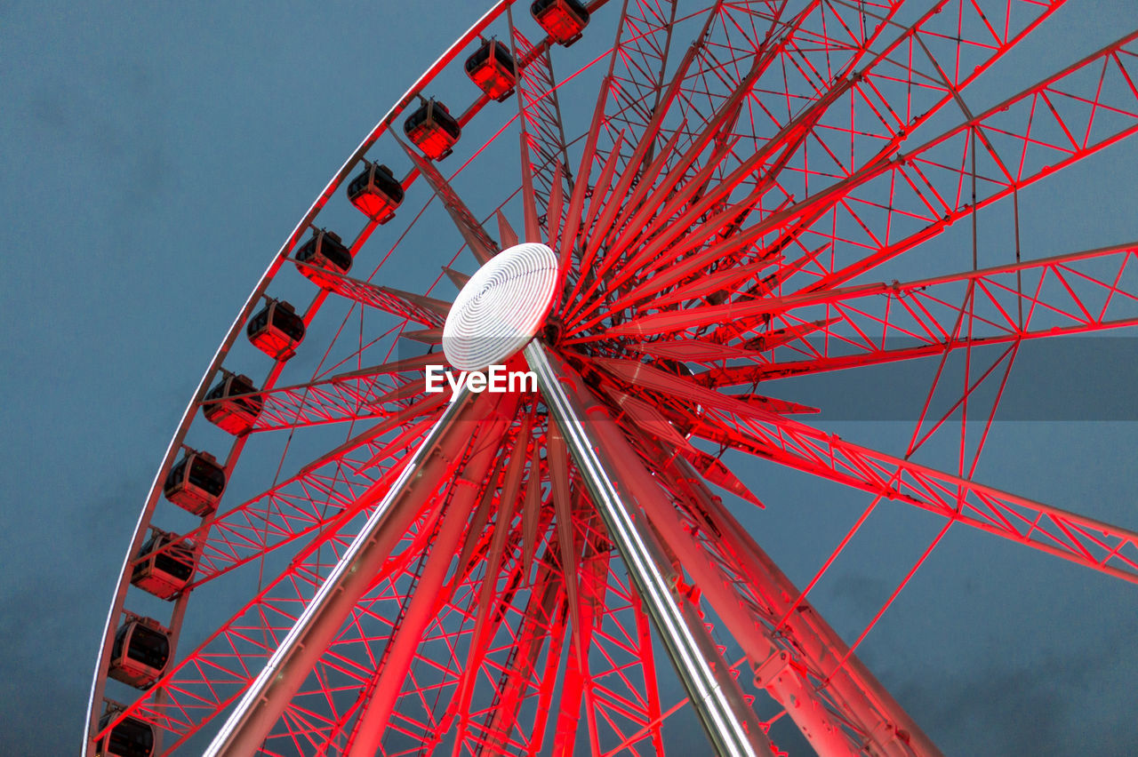 Low angle view of ferris wheel against clear sky