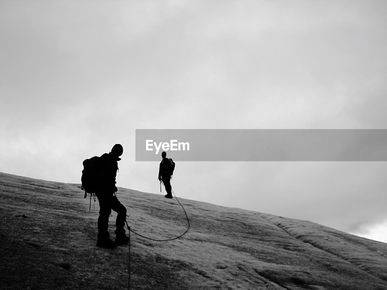 Full length of hikers on mountain against sky