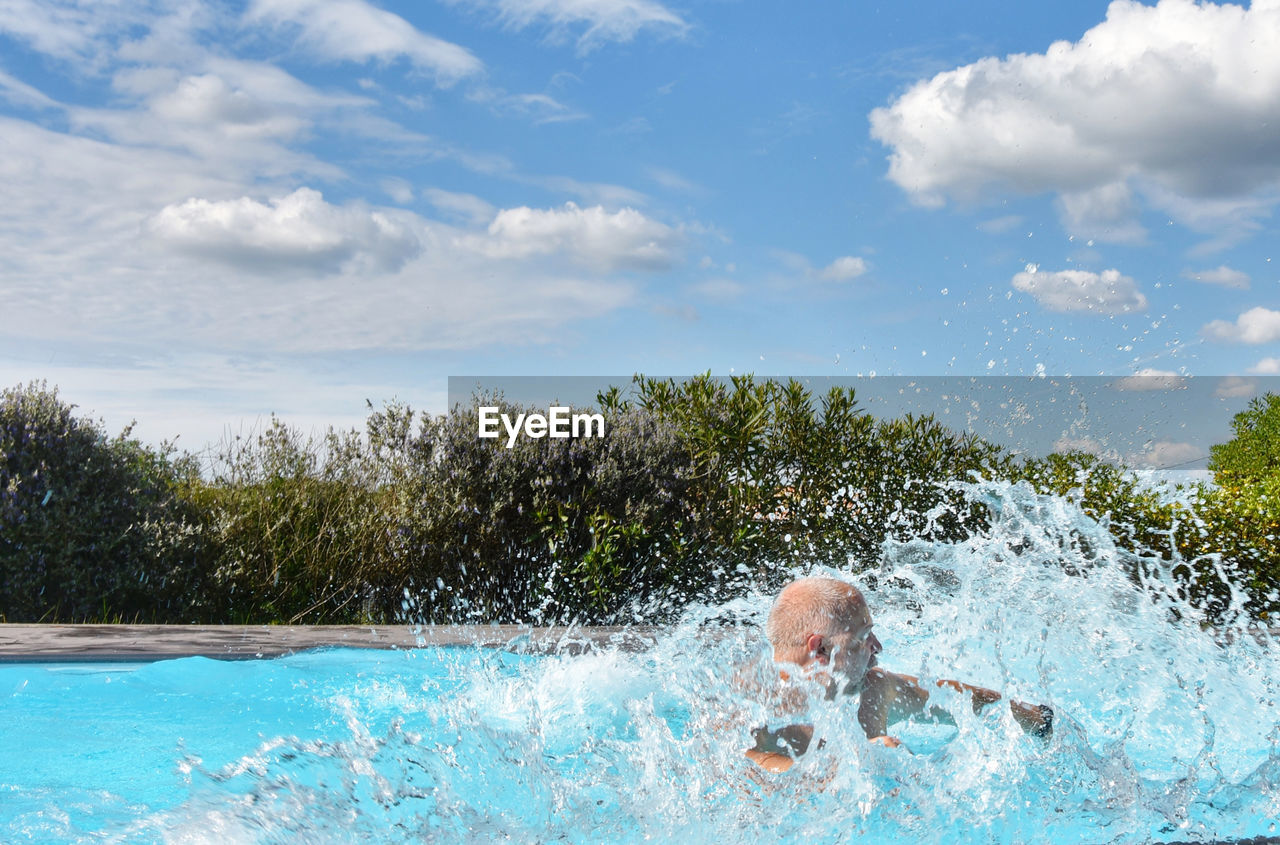 MAN SWIMMING IN POOL