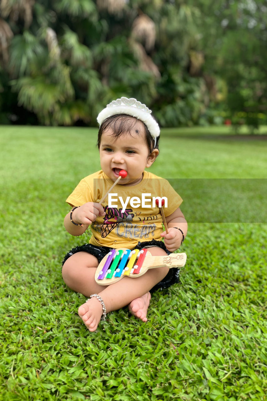 Portrait of cute girl playing with ball 1 year old