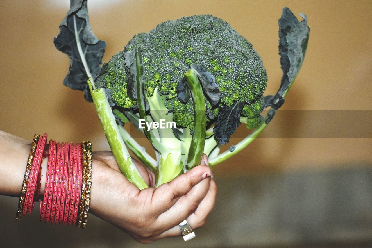 Close-up of woman holding broccoli