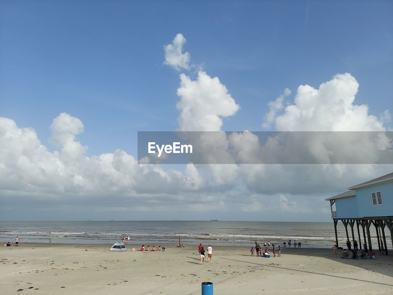 PEOPLE AT BEACH AGAINST SKY