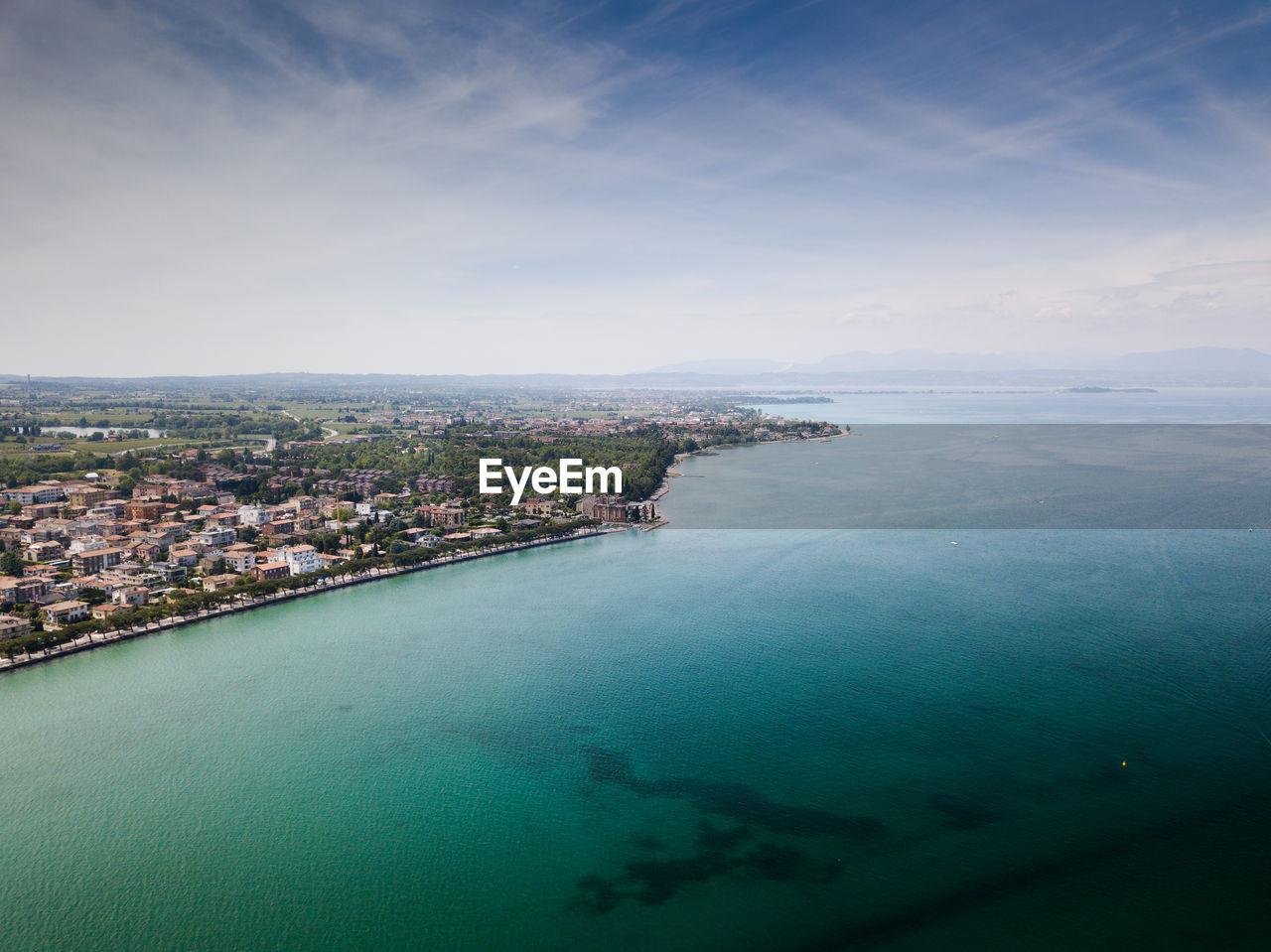 High angle view of sea and city against sky