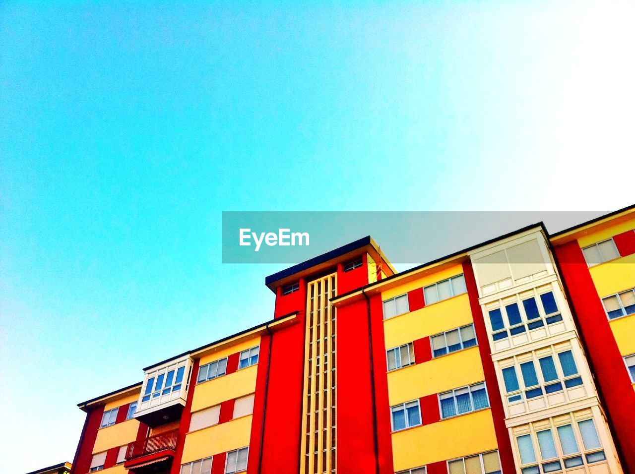 LOW ANGLE VIEW OF RED BUILDING AGAINST SKY