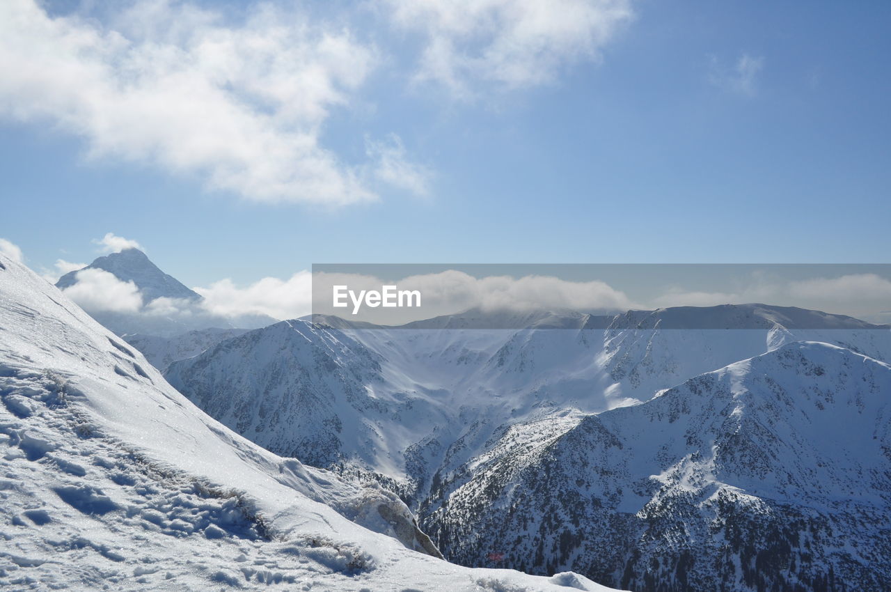 Scenic view of snowcapped mountains against sky