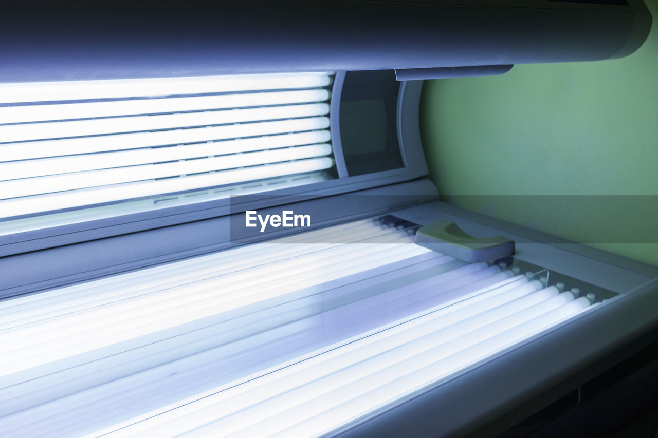 Illuminated ultraviolet light therapy bed at health spa