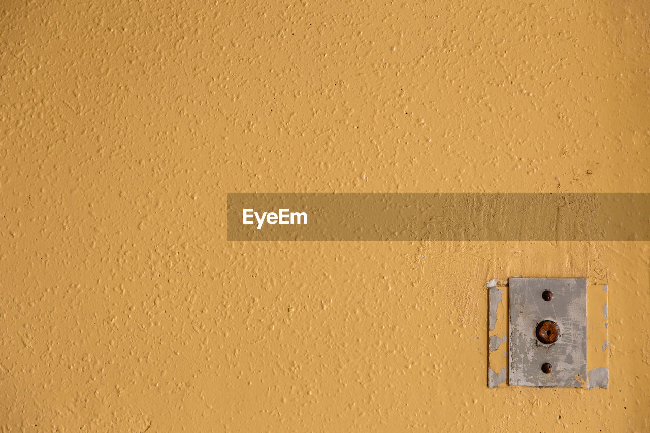 wall - building feature, floor, wall, yellow, no people, wood, built structure, architecture, textured, electricity, metal, light switch, full frame, ceiling, close-up, backgrounds, technology, protection, security, day, building exterior