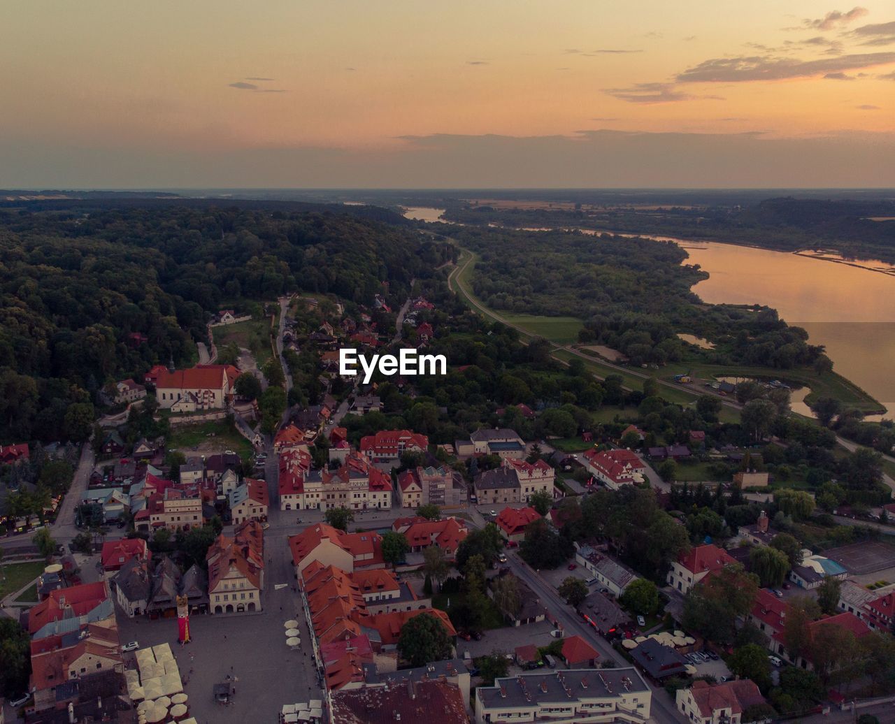 High angle view of townscape by sea against sky