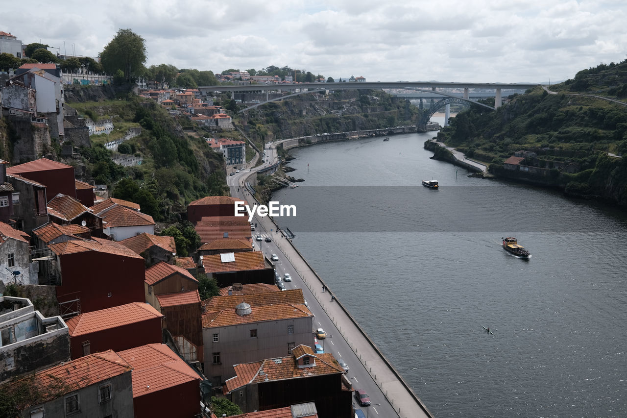 architecture, water, built structure, transportation, building exterior, city, high angle view, nautical vessel, nature, building, travel destinations, mode of transportation, aerial photography, cloud, cityscape, sky, travel, sea, town, aerial view, waterway, coast, no people, outdoors, bridge, tourism, residential district, day, ship, landscape, harbor, environment, land, vehicle, roof, house