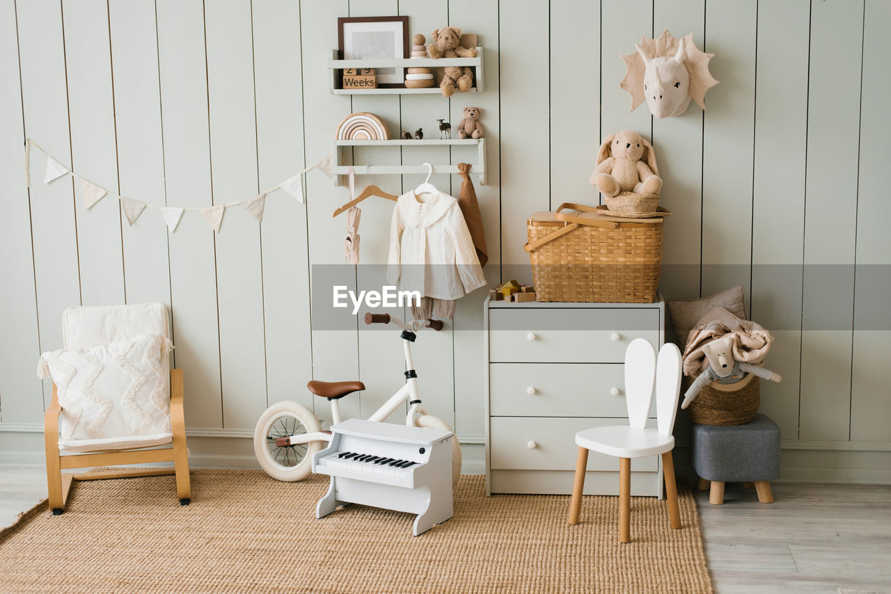 Cozy interior of a children's room, a play area. toys, a bicycle, a piano, a chest of drawers 
