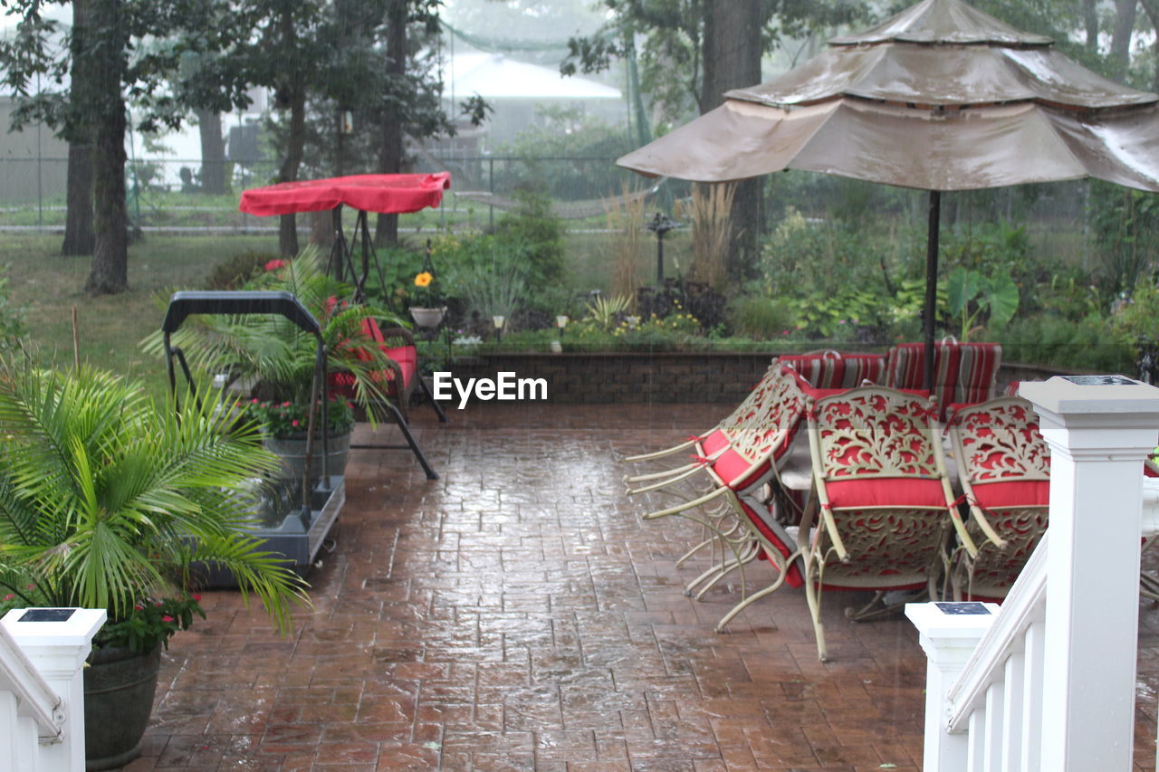 EMPTY CHAIRS AND TABLES AT RESTAURANT