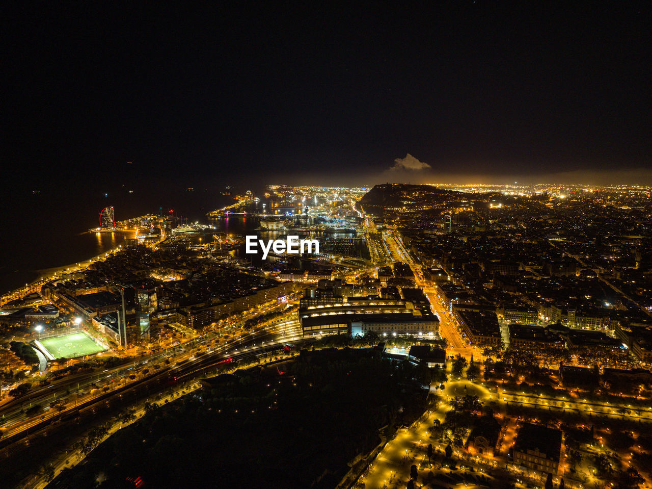 high angle view of illuminated cityscape against sky at night