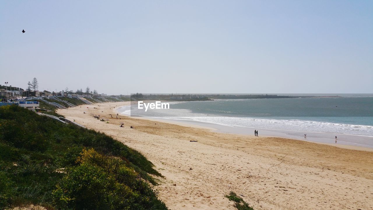 Scenic view of beach against clear sky