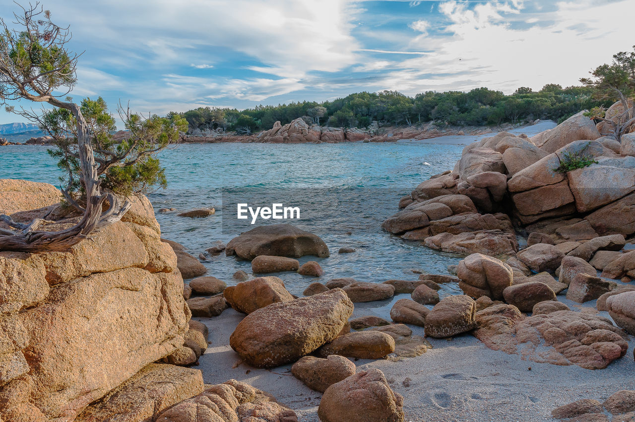 Rocks on beach against sky