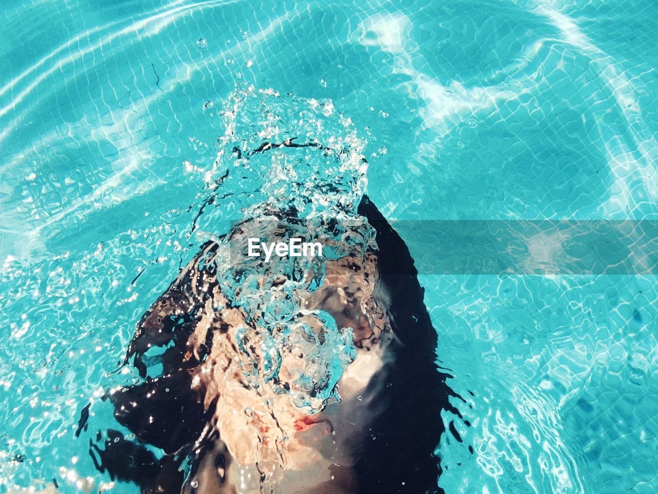 High angle view of woman swimming in pool