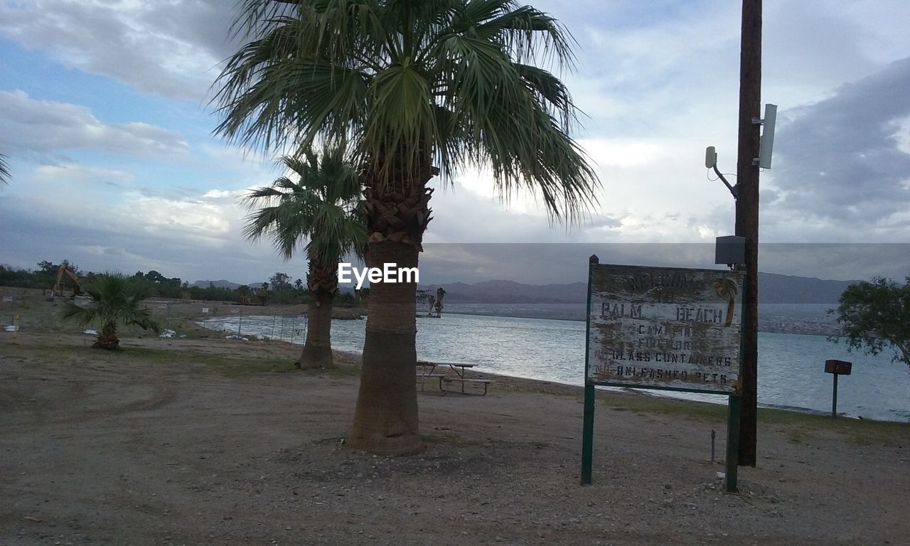 VIEW OF BEACH AGAINST CLOUDY SKY