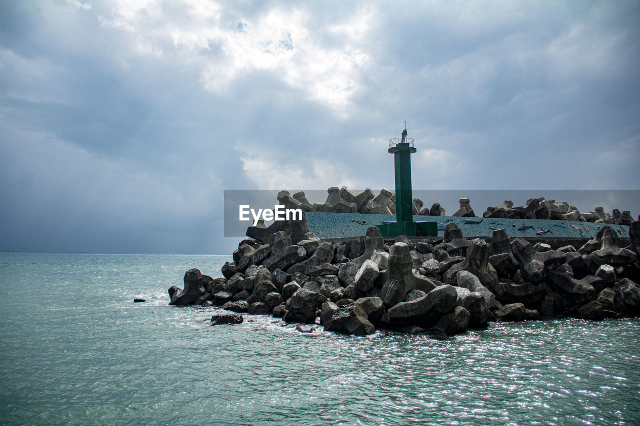 LIGHTHOUSE ON SEA AGAINST SKY