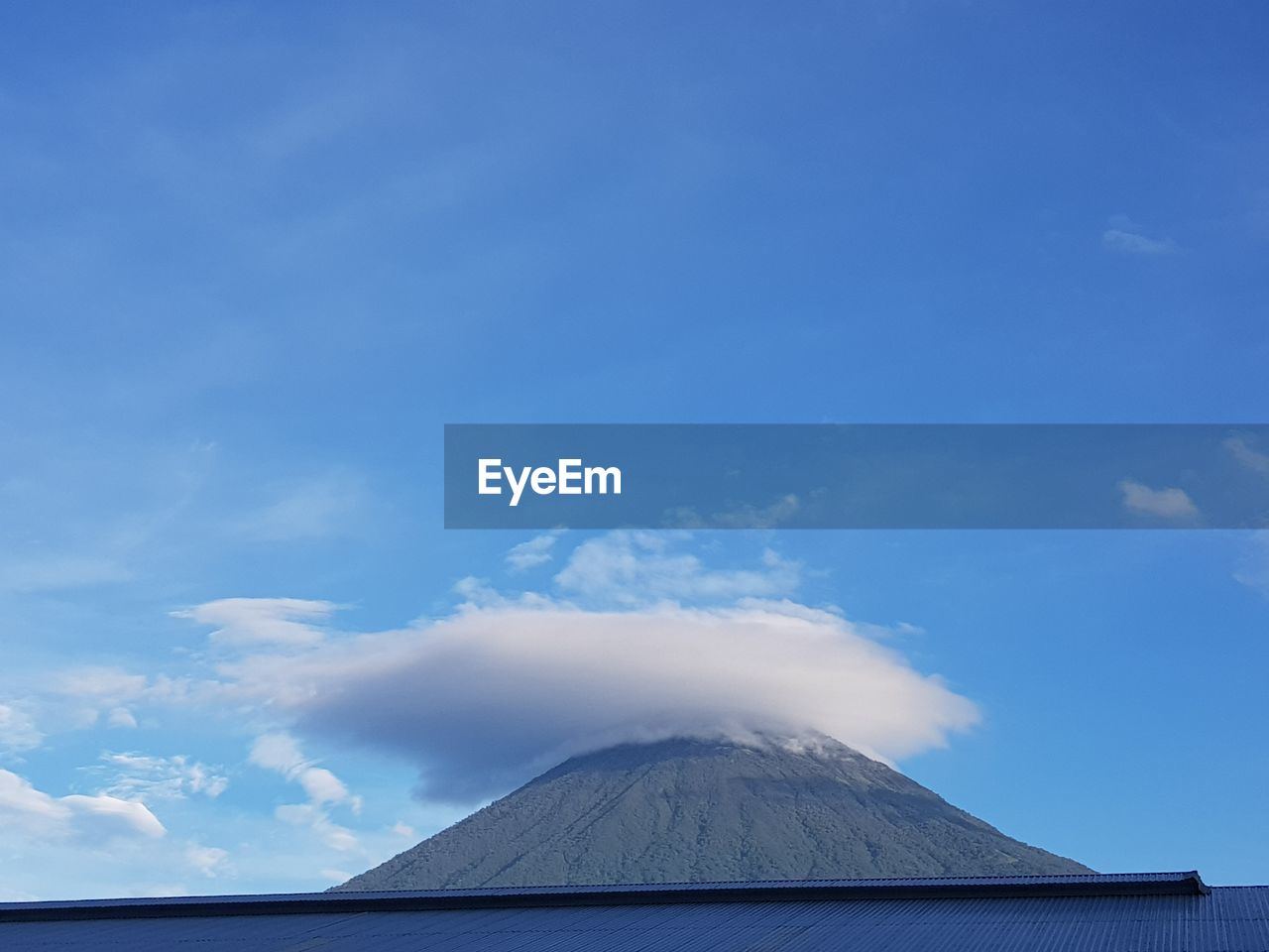 Volcanic mountain against blue sky