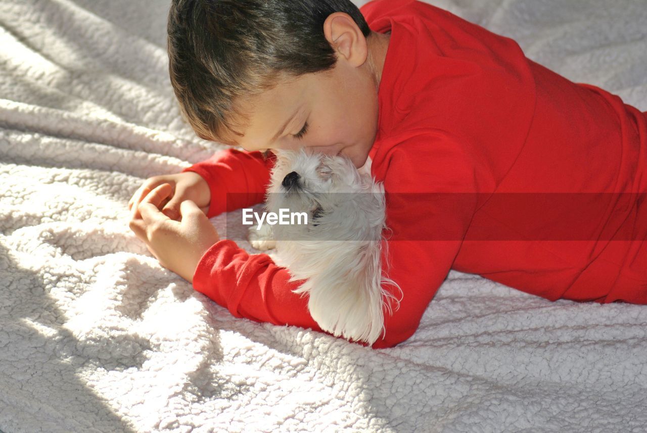 High angle view of boy sleeping on bed at home