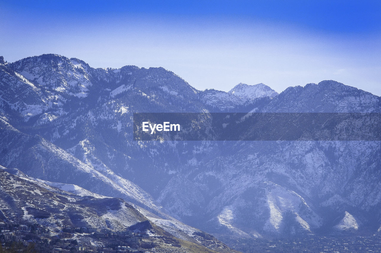 Scenic view of mountains against clear blue sky