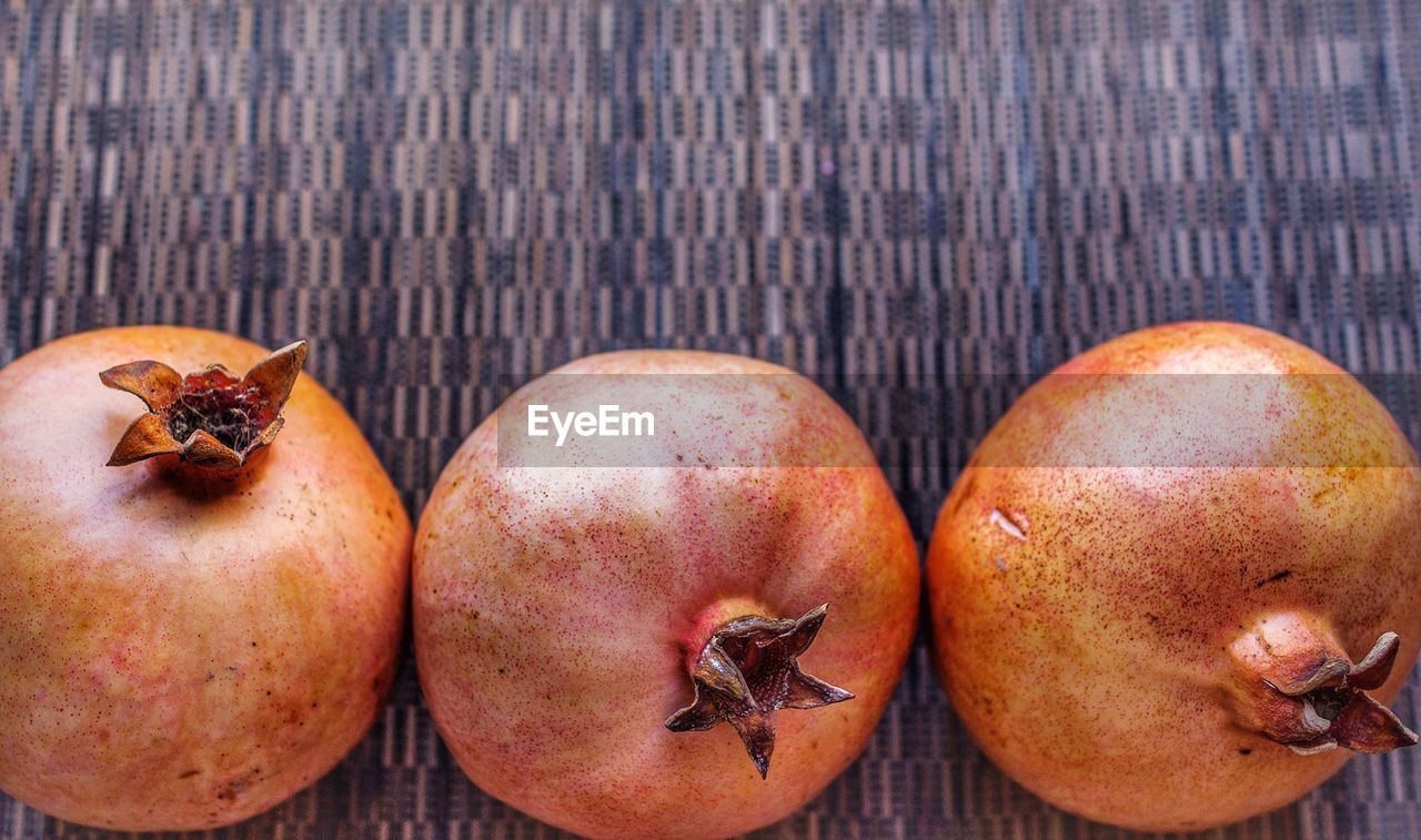 CLOSE-UP OF FRUITS ON TABLE AGAINST WHITE BACKGROUND