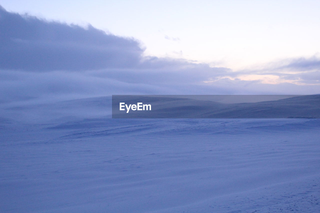 Scenic view of snow covered landscape against sky