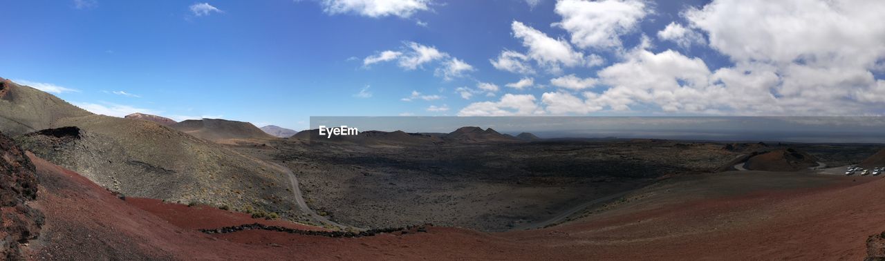 Panoramic view of landscape at timanfaya national park against sky