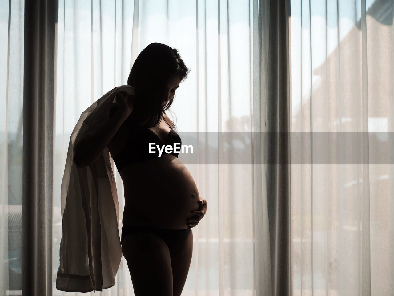 Pregnant woman standing at home