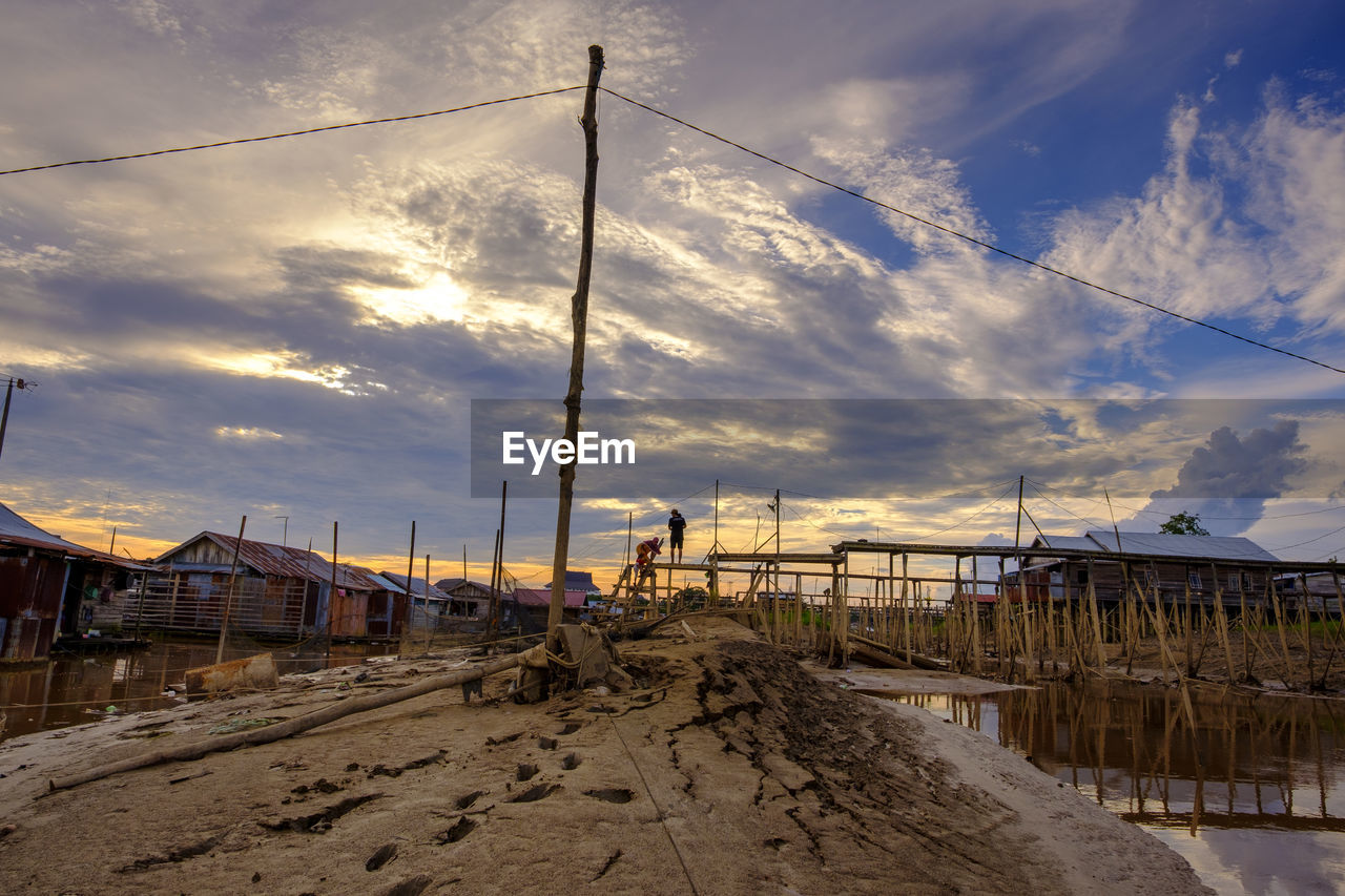 SCENIC VIEW OF BEACH BY BUILDINGS AGAINST SKY