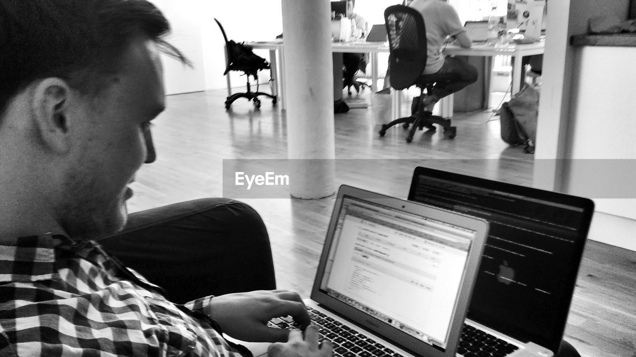 A young man working on his laptop computer