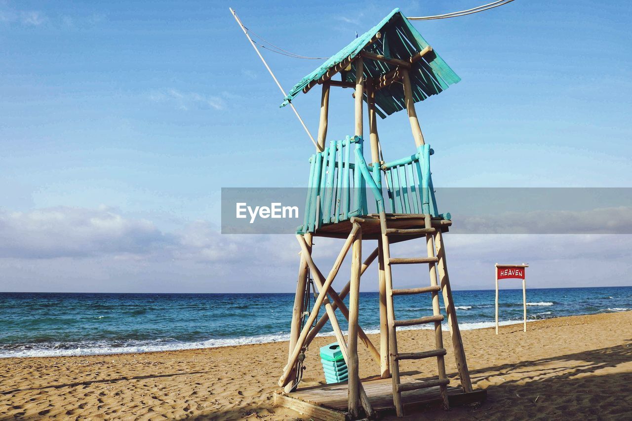 LIFEGUARD HUT BY SEA AGAINST SKY