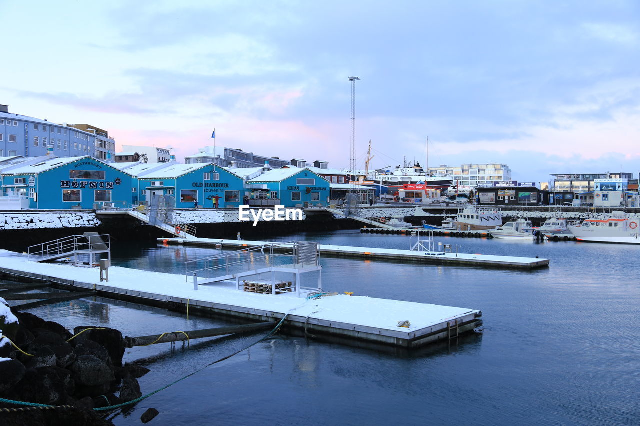 BOATS MOORED AT HARBOR