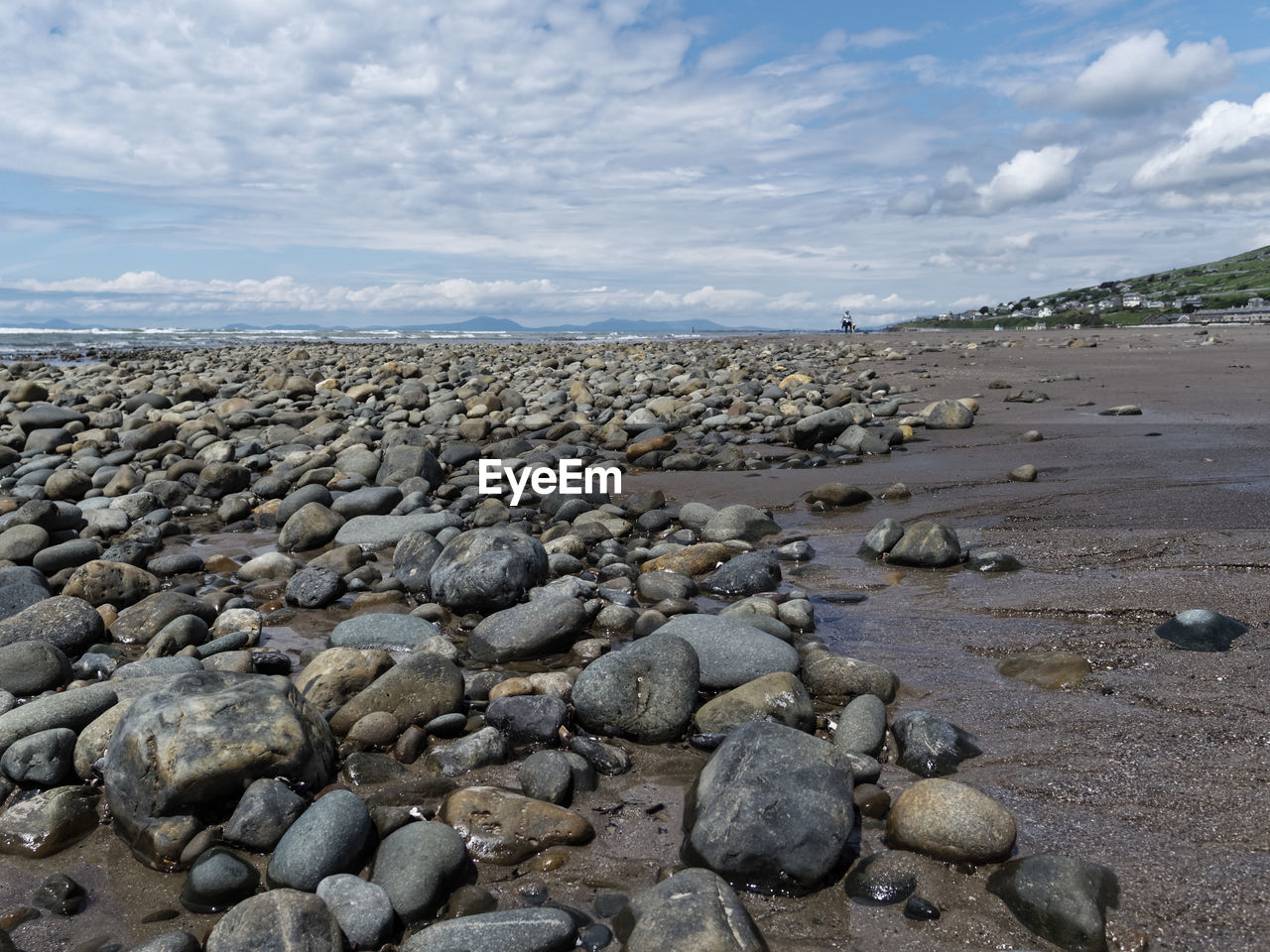 Pebbles on beach against sky