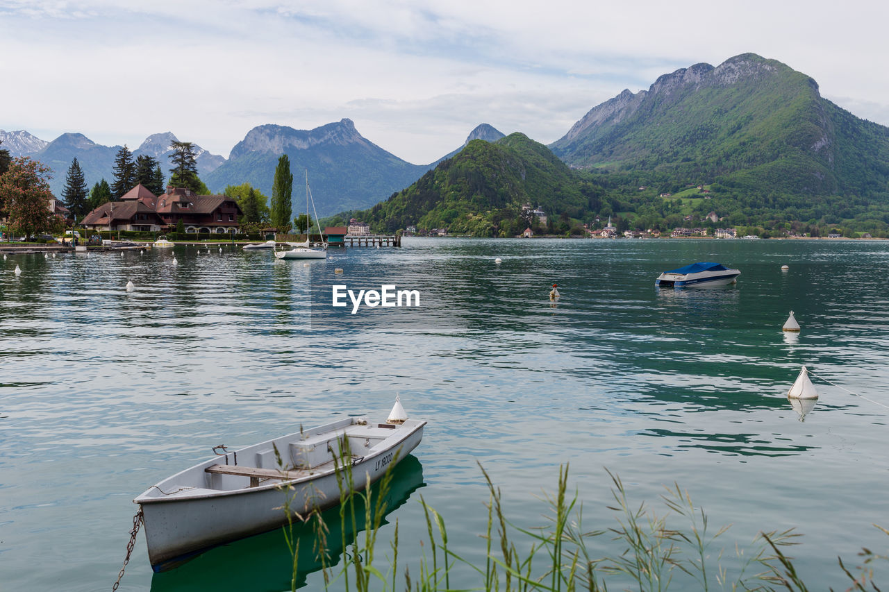 White boat on the lake of annecy in the french alps