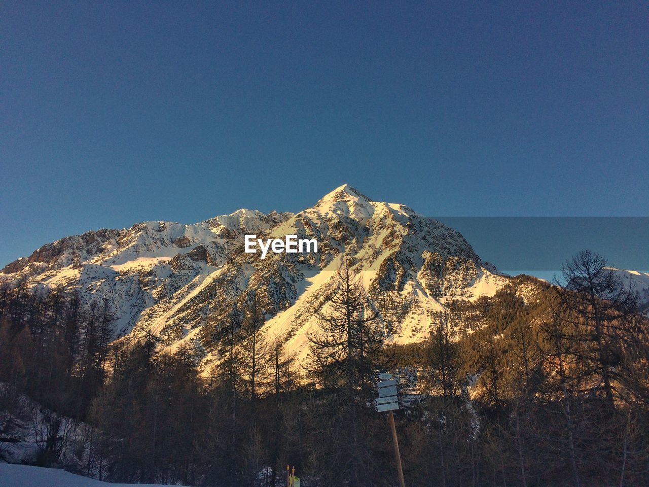 Scenic view of snowcapped mountains against clear blue sky
