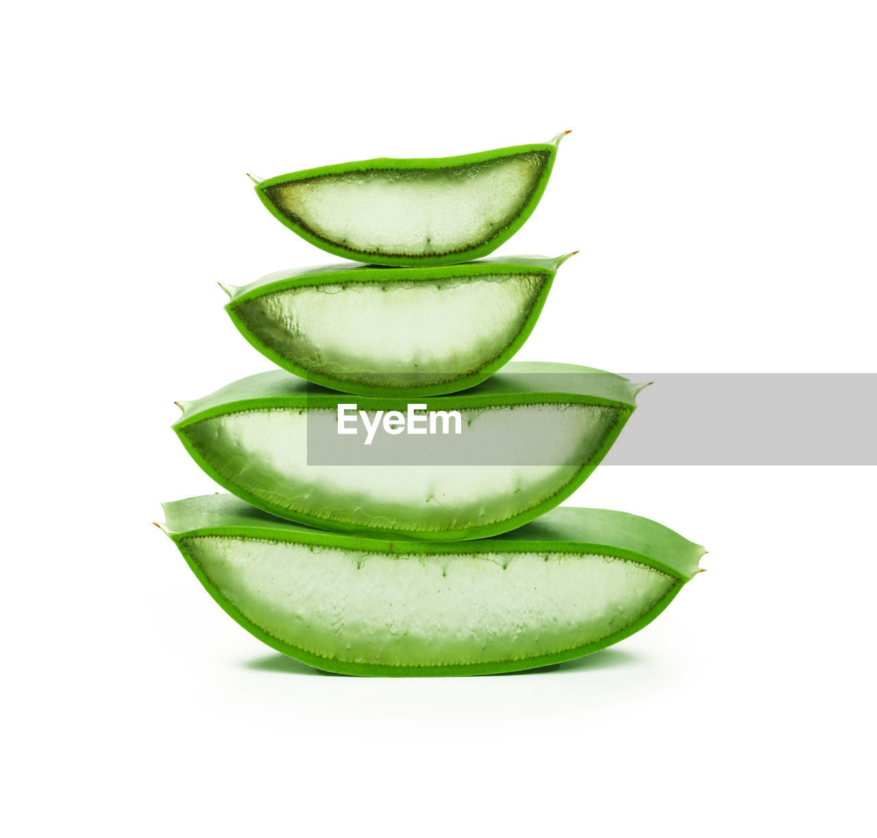 Close up stack of fresh green aloe vera slices full of juicy gel isolated on white background