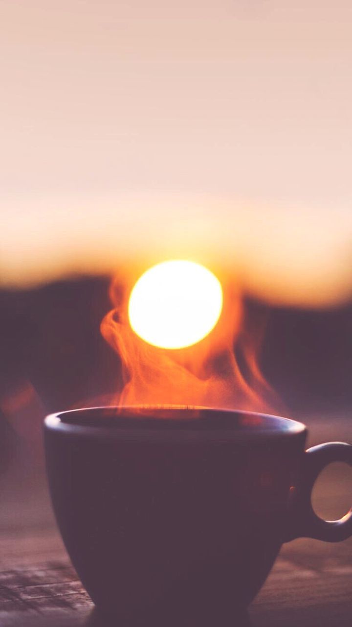 CLOSE-UP OF DRINK AGAINST SUNSET