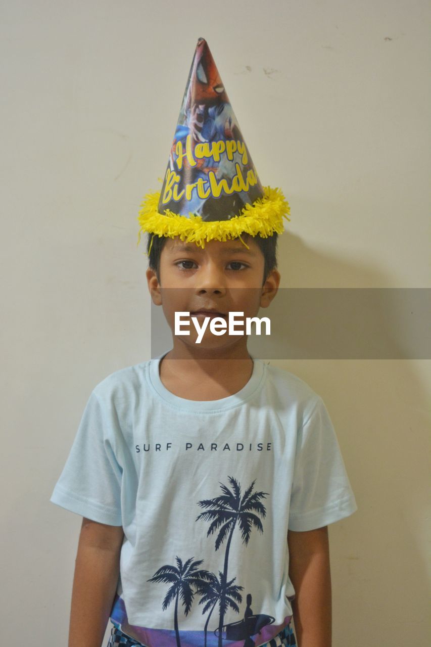 childhood, child, one person, portrait, yellow, front view, men, toddler, innocence, standing, clothing, looking at camera, waist up, indoors, casual clothing, crown, cute, royalty, smiling, studio shot, celebration, emotion, art, fun, costume, hat, creativity, person, t-shirt, spring