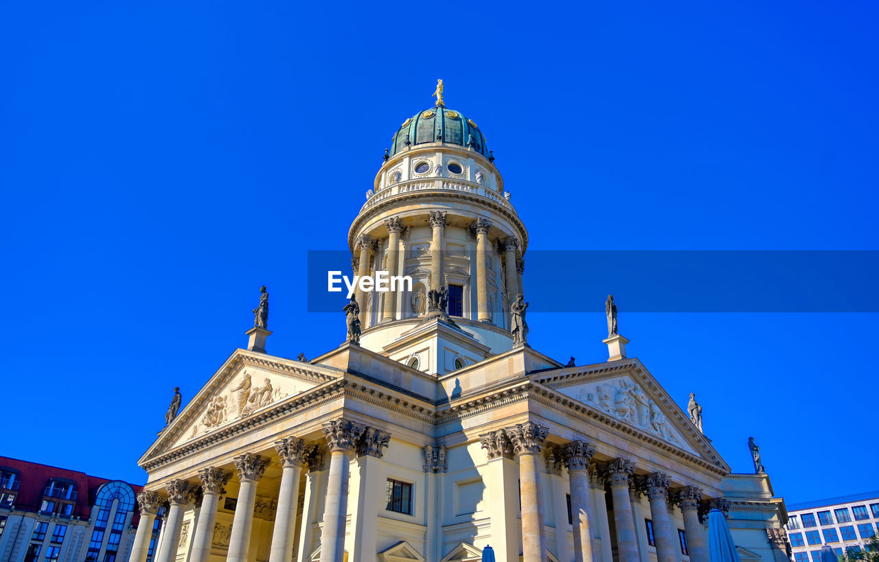 LOW ANGLE VIEW OF CATHEDRAL AGAINST BLUE SKY