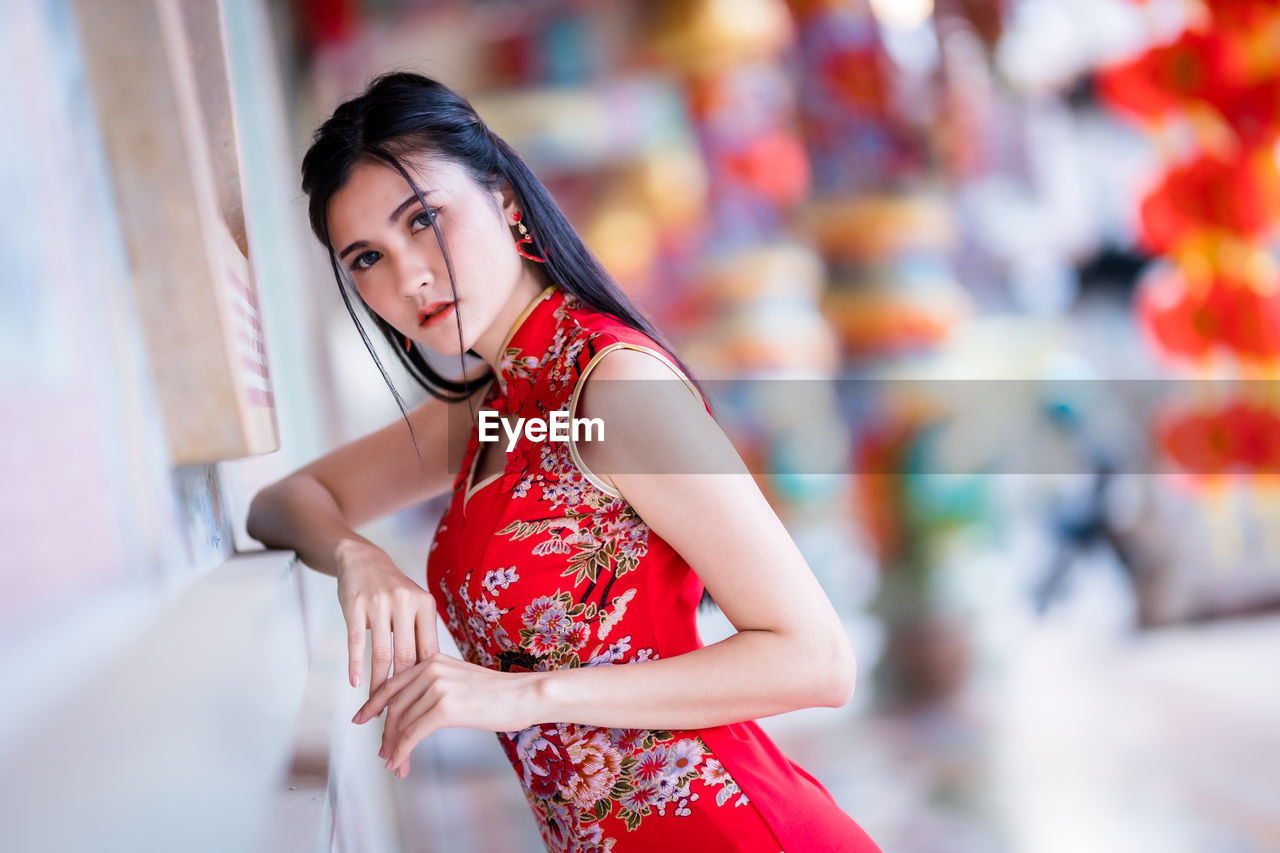 Portrait of beautiful young woman standing outdoors