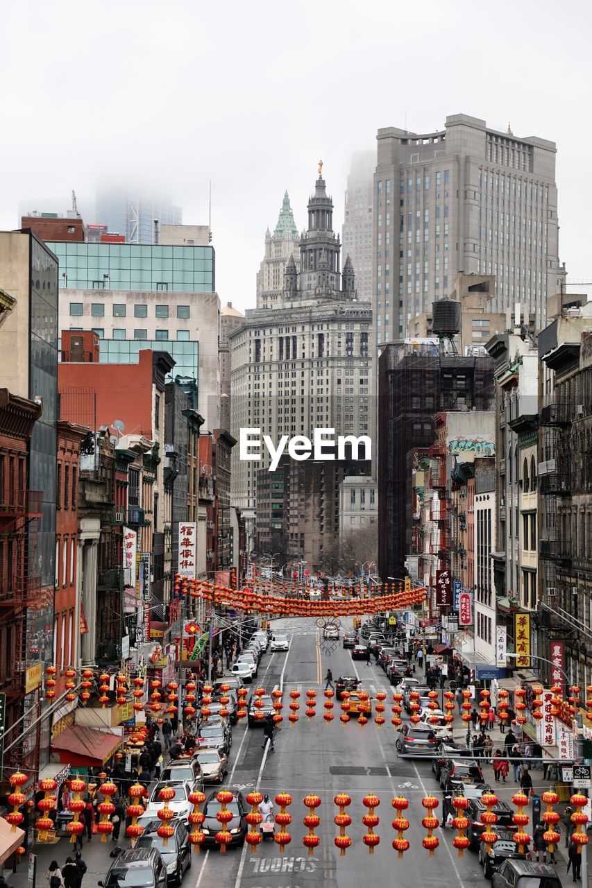 View of city street and buildings against sky