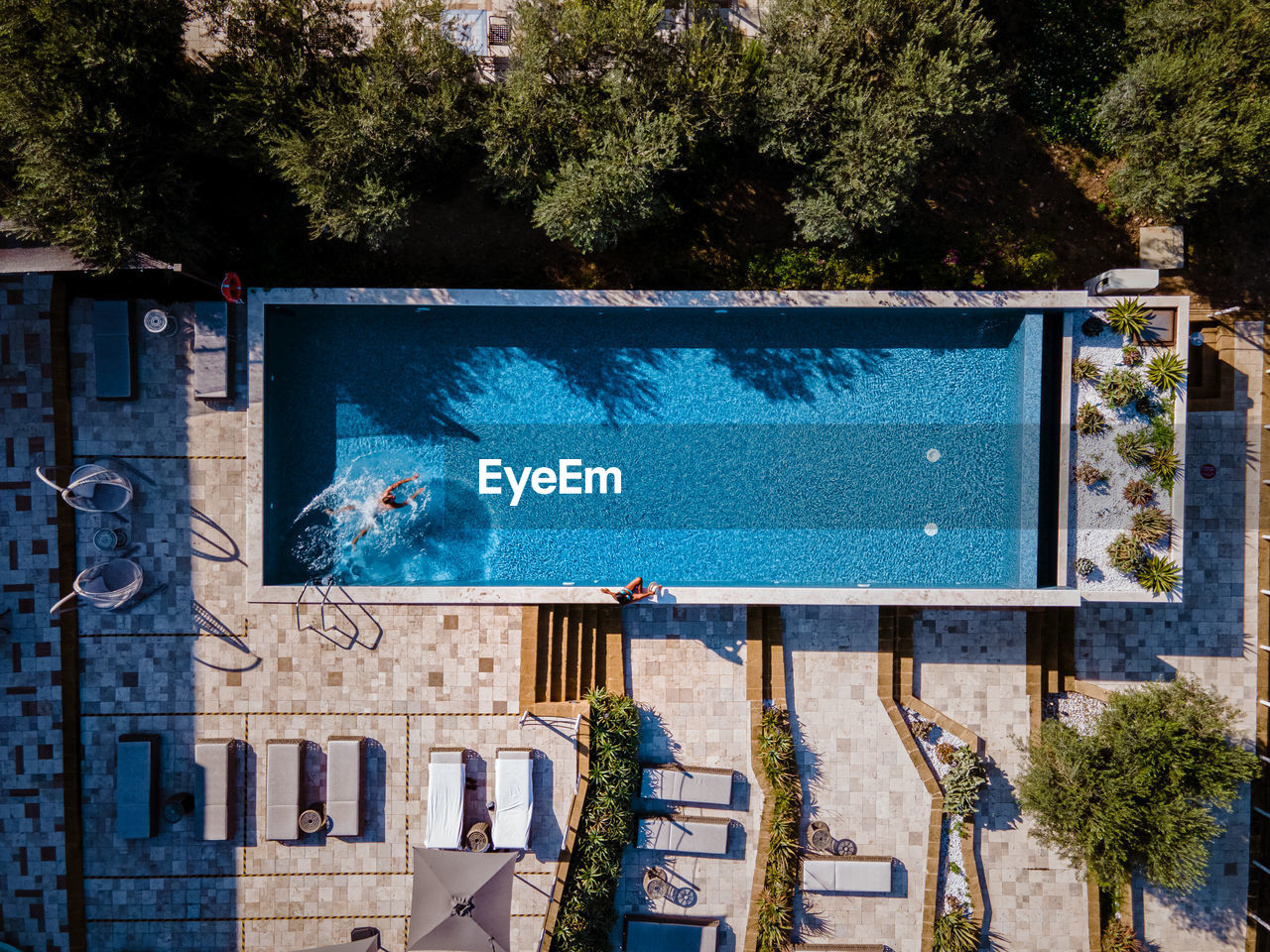 Aerial view of man swimming in swimming pool