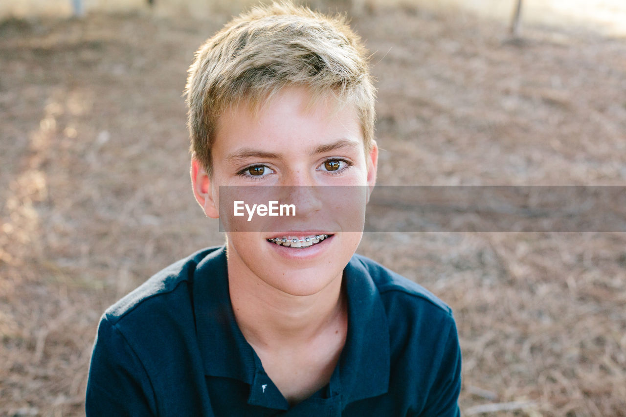 Portrait of a handsome teen boy with braces
