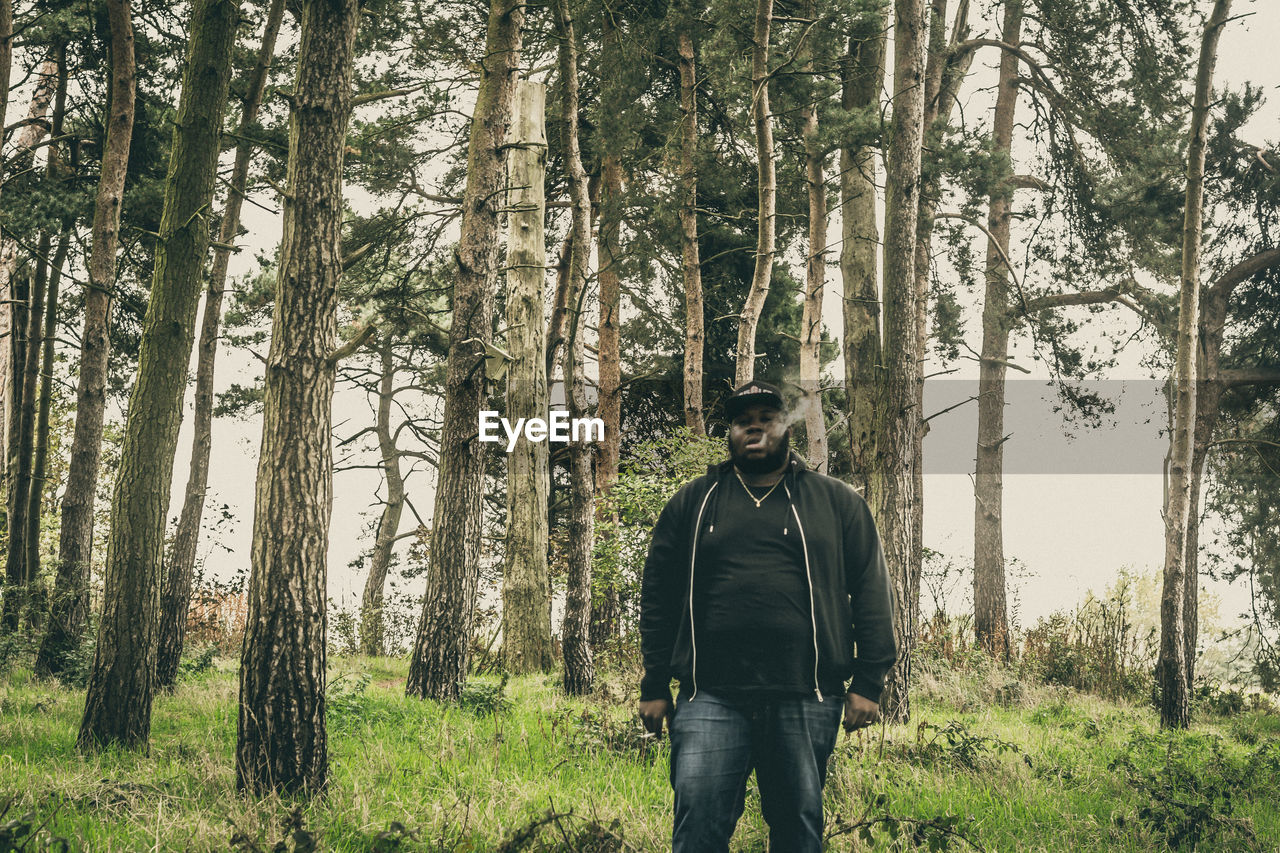 Portrait of man smoking in forest