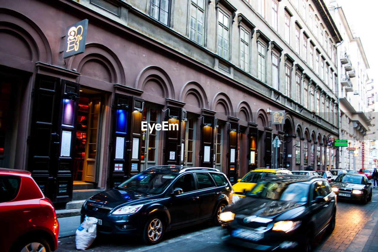 Cars on street by buildings in city