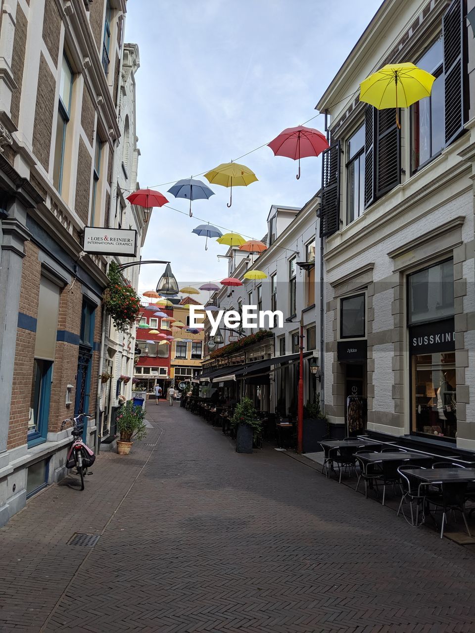 STREET AMIDST BUILDINGS AGAINST SKY