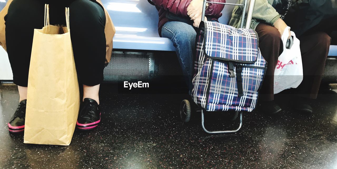 LOW SECTION OF WOMAN SITTING ON FLOOR