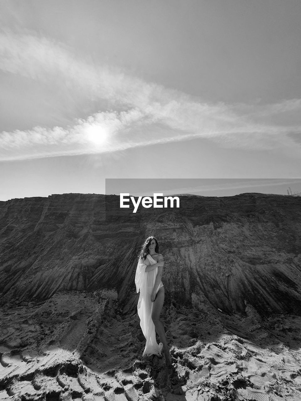 Woman standing on land against sky