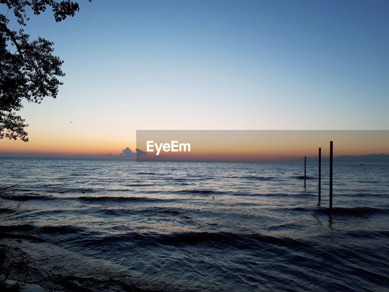 Scenic view of sea against clear sky during sunset