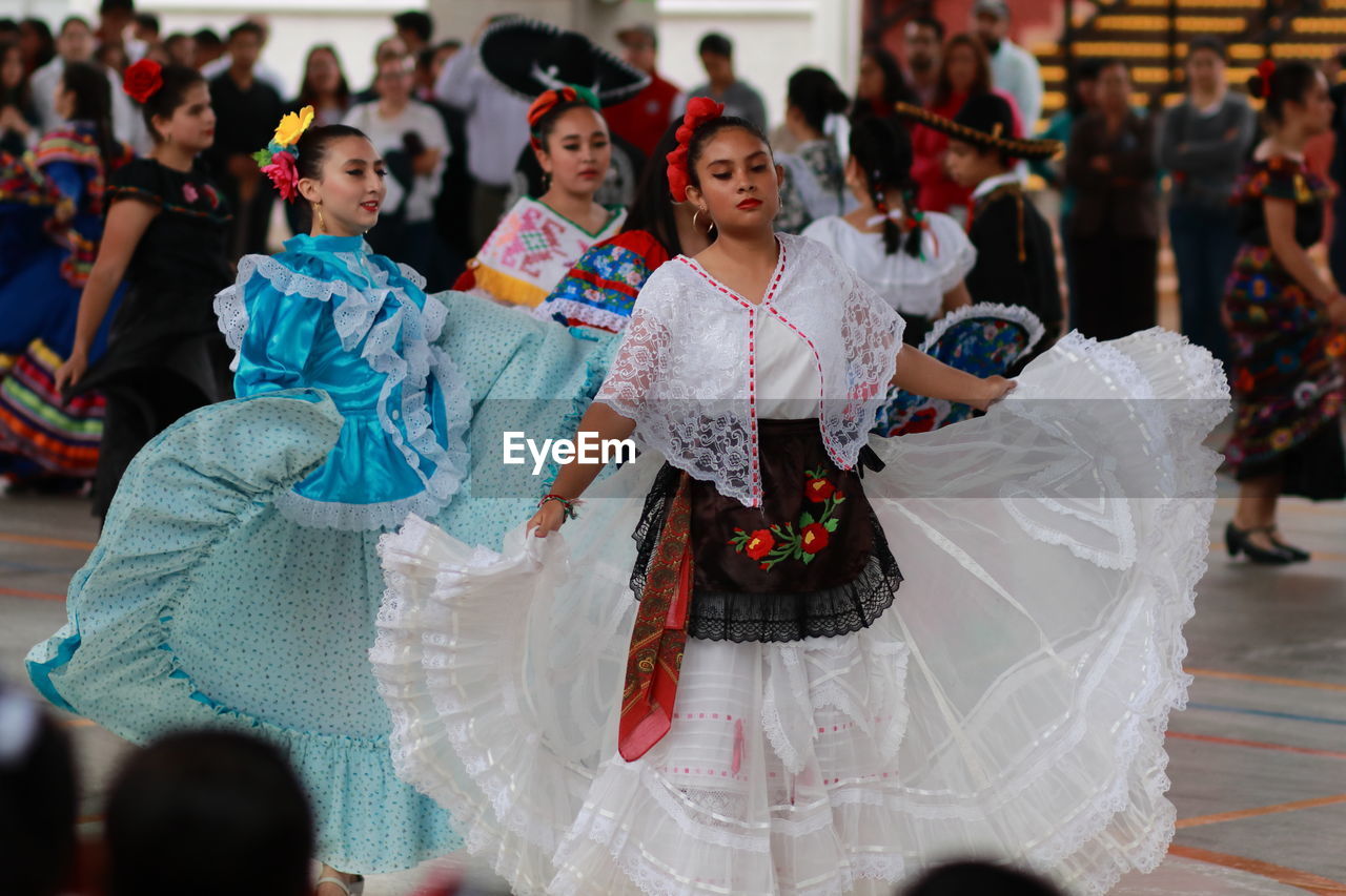 GROUP OF PEOPLE IN FRONT OF TRADITIONAL CLOTHING